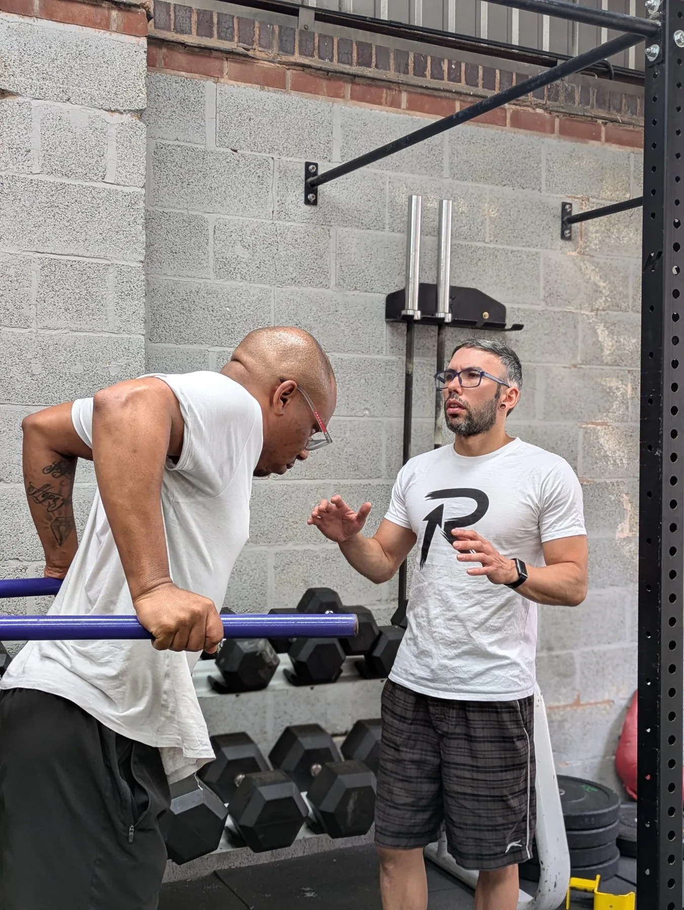 Ahsan coaching a client through a set of dips